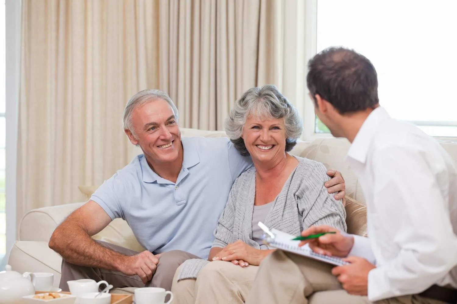 Older woman reviewing her care paperwork at a kitchen table